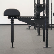 Side view of Gorila Venom GHD securely mounted on a power rack, highlighting the compact rack-mounted frame and adjustable foot support system.