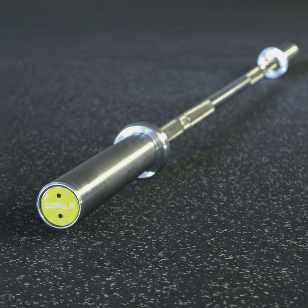 Gorila Women Training Bar 2.0 endcap with yellow logo – precision-engineered barbell with four large needle bearings, brass bushings, and 180,000 PSI tensile steel