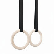 Gorila Wooden Gym Rings set with heavy-duty black straps and metal buckles, ideal for CrossFit-style and functional training workouts.