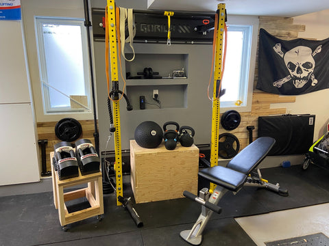 Home gym equipment setup including rack and bench in Canada