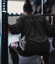 Crossfit Athlete wearing a Tested For Animals Heavy Tee by Gorila Fitness in Dark commercial gym