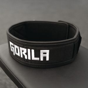 The 4 inch wide Gorila Fitness black nylon lifting belt with a distinctive 'GORILA' logo in bold white letters. This belt features a unique 'Python clip' designed to alleviate stress from the Velcro fastener. The clip ensures that the nylon strap bears th